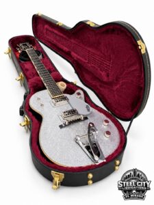 Gretsch silver sparkle electric guitar in burgundy-lined hard-shell case